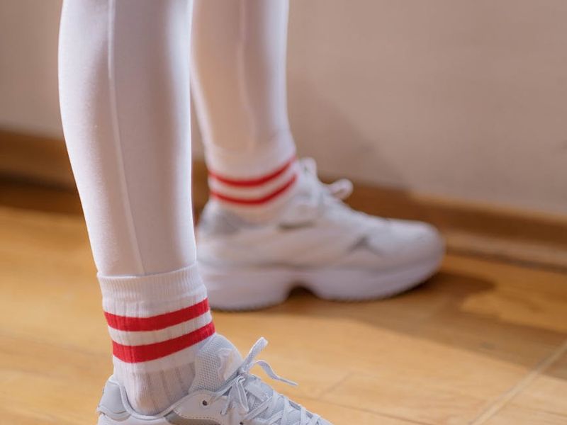 Close up of sports shoes stepping on a clean wooden floor in a gym